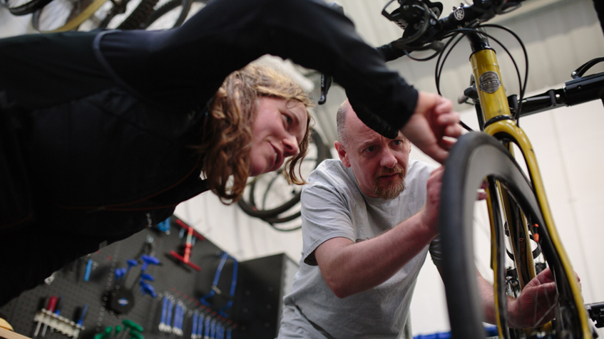 Photo of record-bid cyclist Jenny Graham doing last minute checks with bike builder Steven Shand