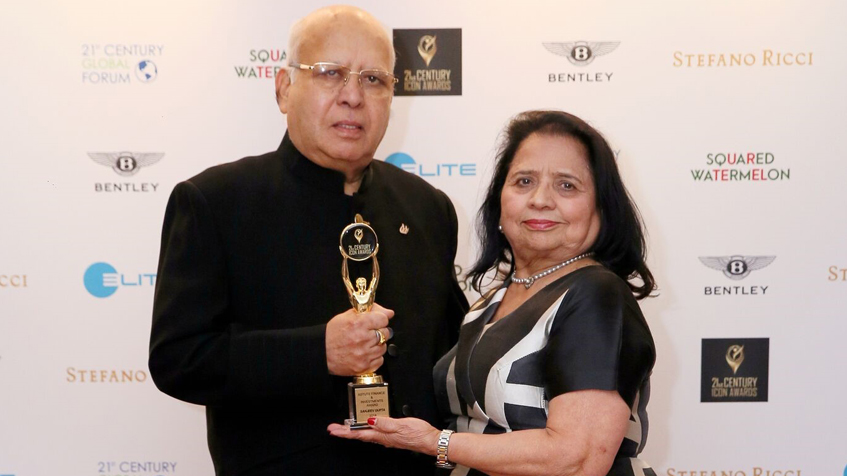 Photo of Mr & Mrs PK Gupta accepting the 21st Century Icon Award on behalf of Sanjeev Gupta